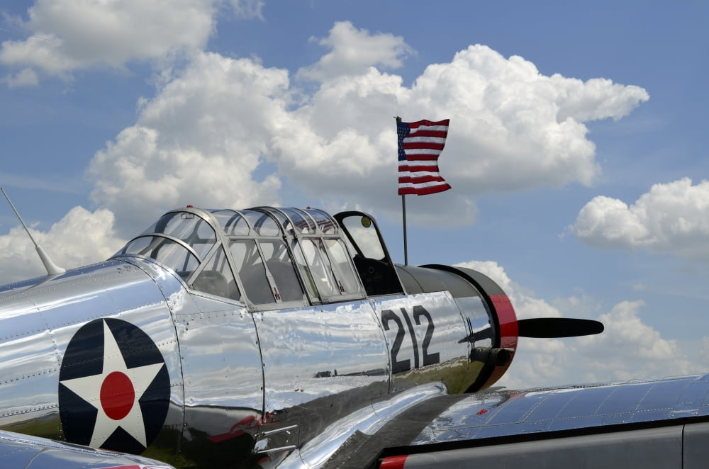 A BT-13 Valiant trainer aircraft with American Flag Canvas Art - Stocktrek Images (35 x 23)