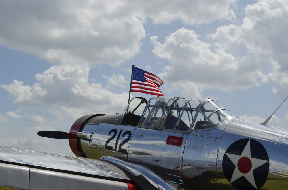 A BT-13 Valiant trainer aircraft with American Flag Canvas Art - Stocktrek Images (35 x 23)
