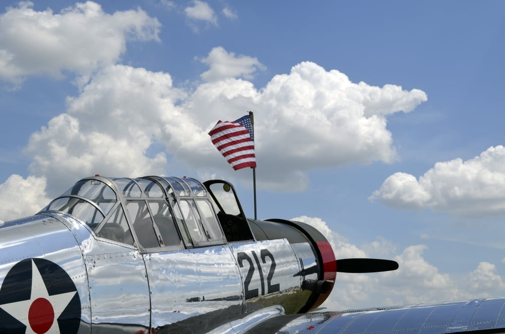 A BT-13 Valiant trainer aircraft with American Flag Canvas Art - Stocktrek Images (35 x 23)