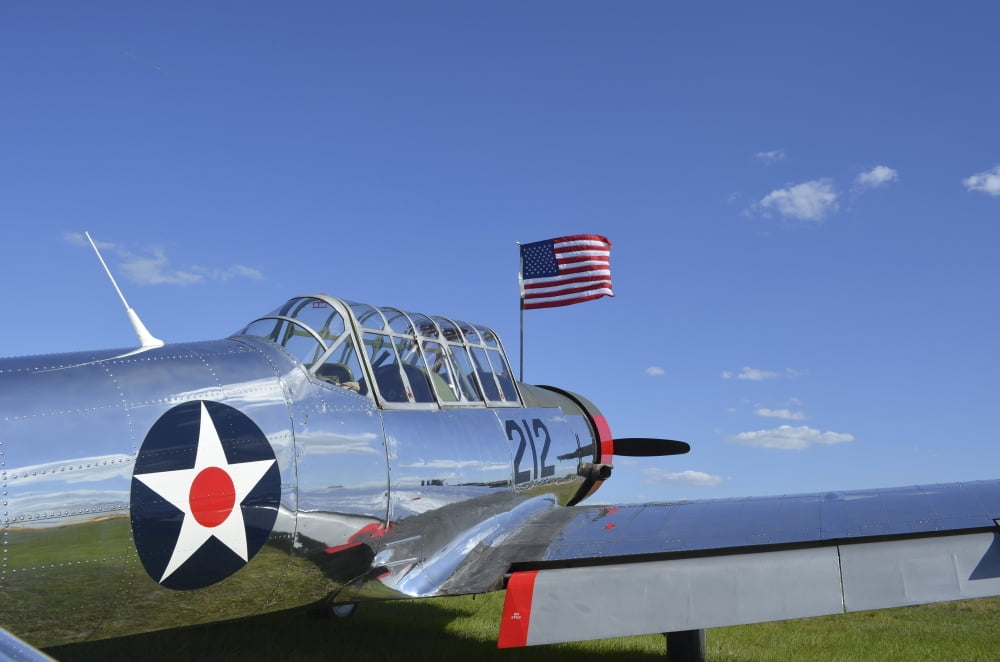 A BT-13 Valiant trainer aircraft with American Flag Canvas Art - Stocktrek Images (35 x 23)