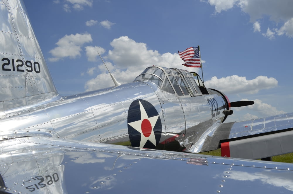 A BT-13 Valiant trainer aircraft with American Flag Canvas Art - Stocktrek Images (35 x 23)