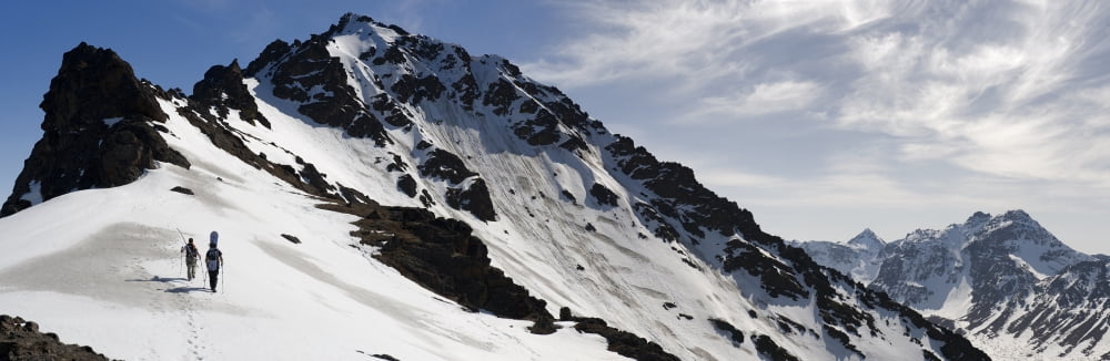 A Backcountry Snowboarder And Skier Hike Up The West Ridge Of Powerline Pass Near Anchorage Alaska Canvas Art - Chris Miller Design Pics (44 x 15)
