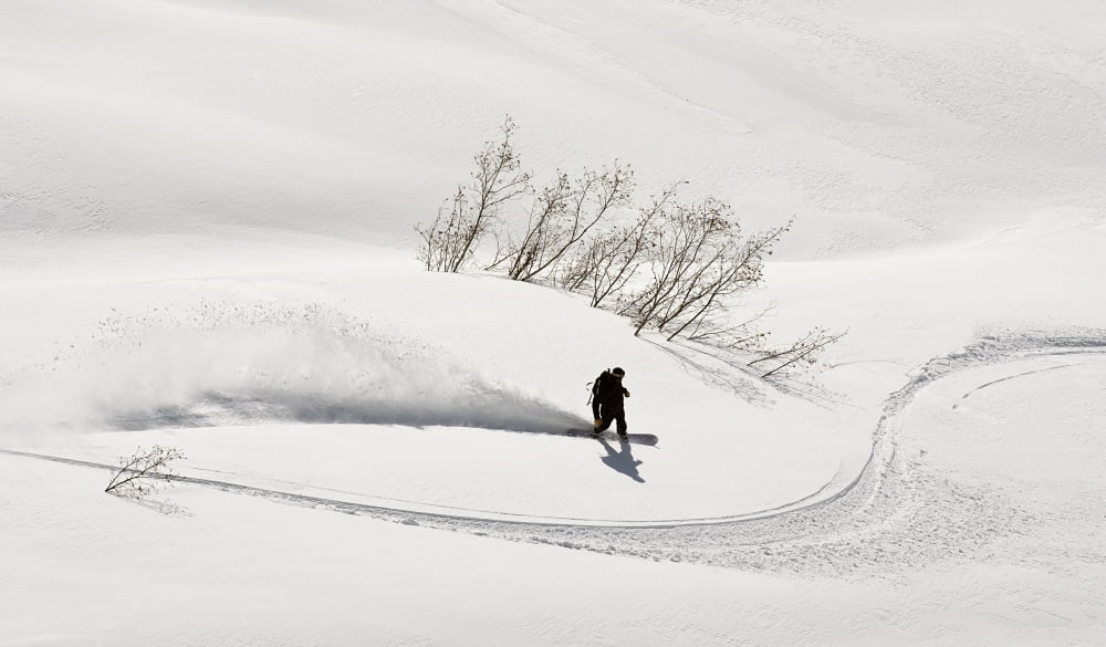 A Backcountry Snowboarder Carving In Turnagain Pass Southcentral Alaska Canvas Art - Chris Miller Design Pics (19 x 11)