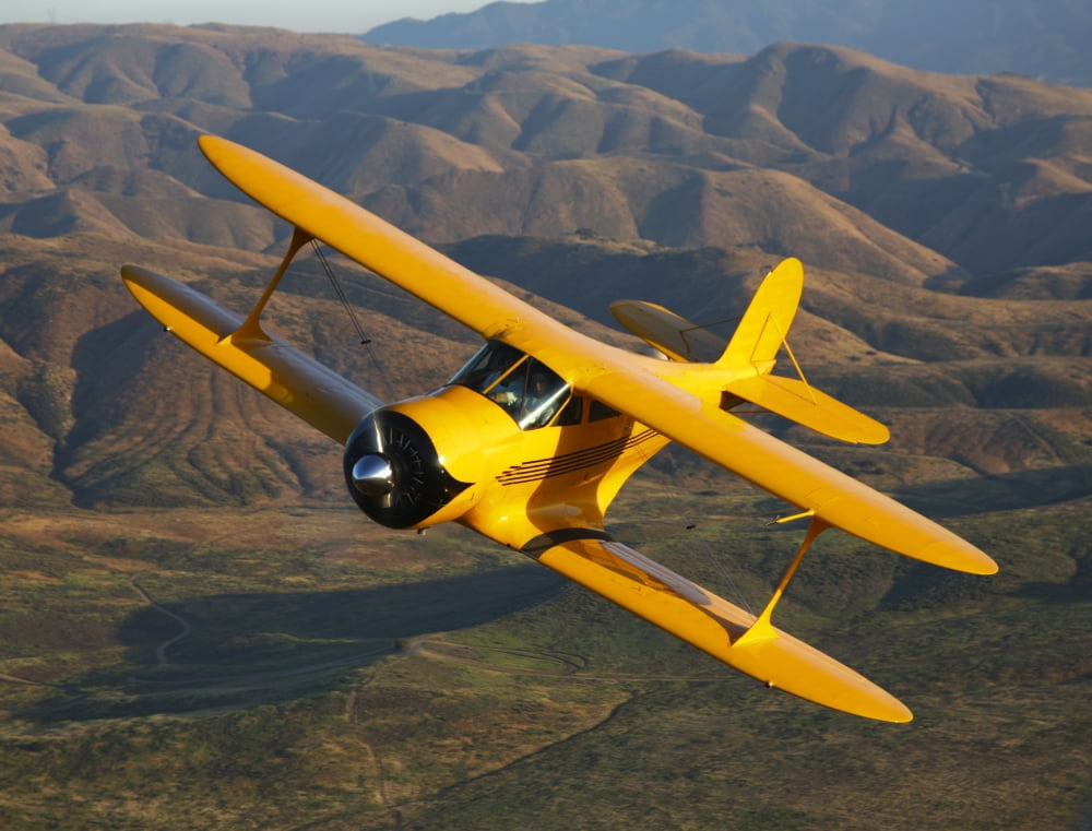 A Beechcraft Model B17R Staggerwing in flight Canvas Art - Scott GermainStocktrek Images (32 x 25)