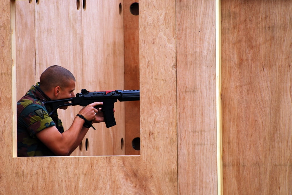 A Belgian soldier trying out a shooting position with his FNC rifle in an improvised hut Canvas Art - Luc De JaegerStocktrek Images (34 x 23)