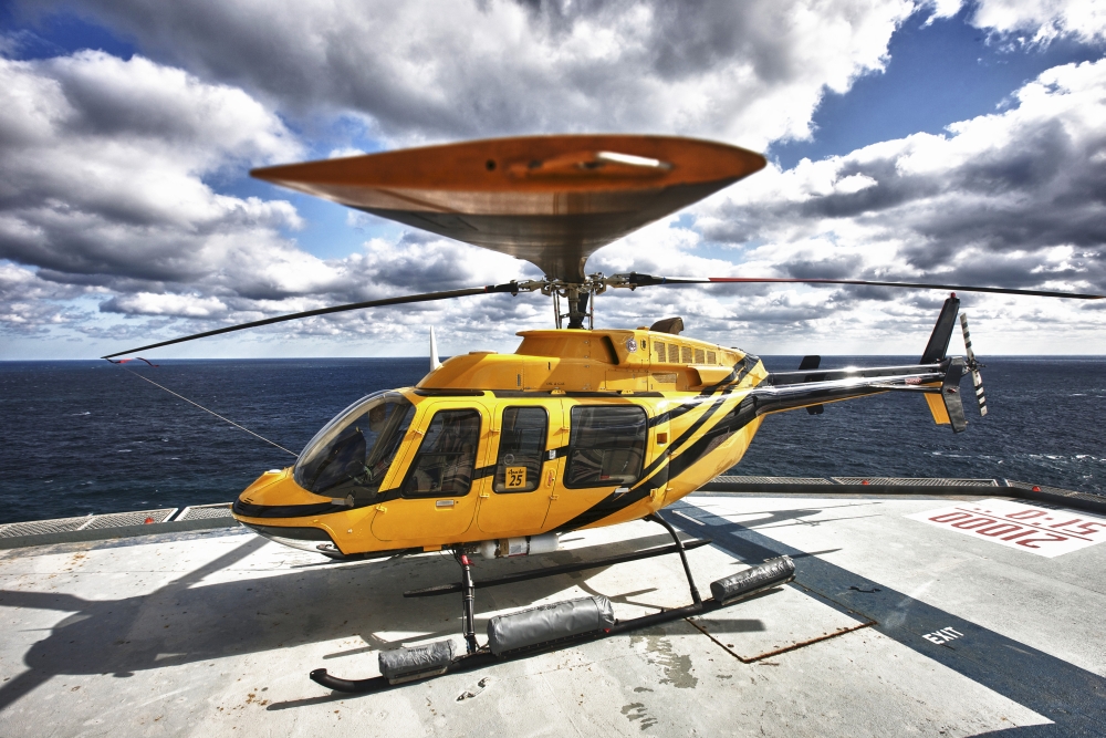 A Bell 407 utility helicopter on the helipad of an oil rig Canvas Art - Terry MooreStocktrek Images (17 x 12)