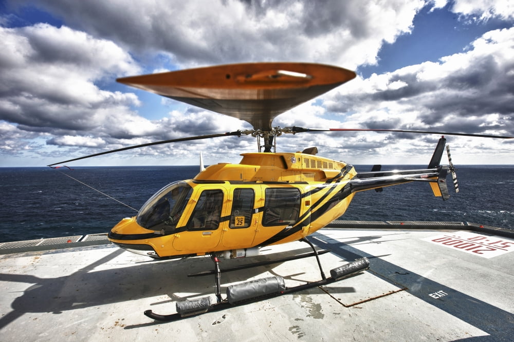 A Bell 407 utility helicopter on the helipad of an oil rig Canvas Art - Terry MooreStocktrek Images (34 x 23)