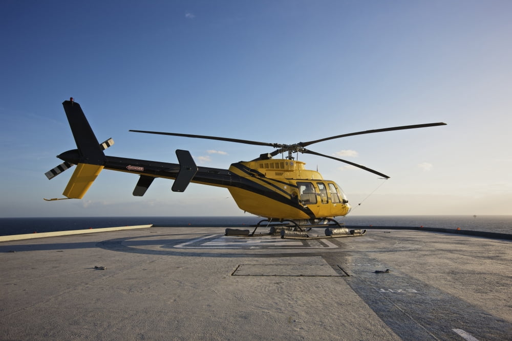 A Bell 407 utility helicopter on the helipad of an oil rig Canvas Art - Terry MooreStocktrek Images (35 x 24)