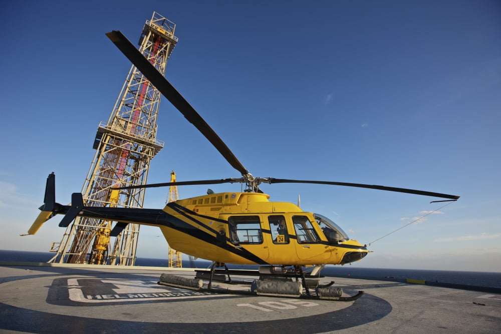 A Bell 407 utility helicopter on the helipad of an oil rig Canvas Art - Terry MooreStocktrek Images (35 x 24)
