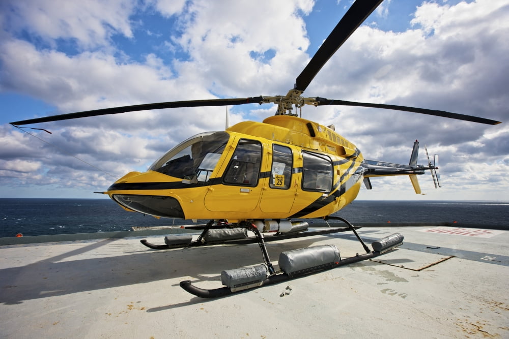 A Bell 407 utility helicopter on the helipad of an oil rig Canvas Art - Terry MooreStocktrek Images (35 x 24)