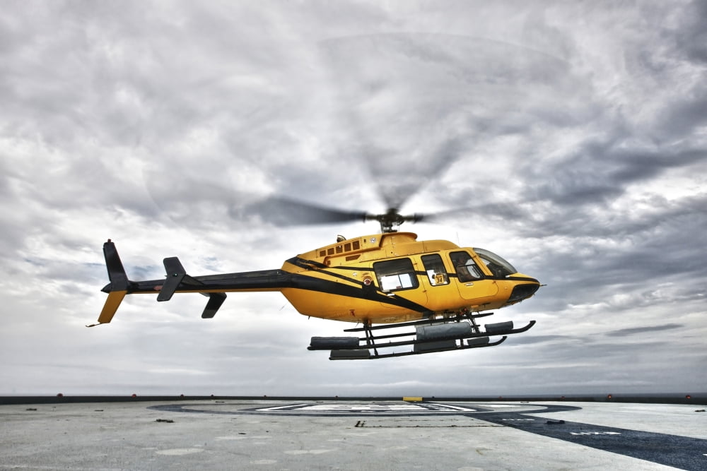 A Bell 407 utility helicopter prepares to land on an oil rig Canvas Art - Terry MooreStocktrek Images (35 x 23)