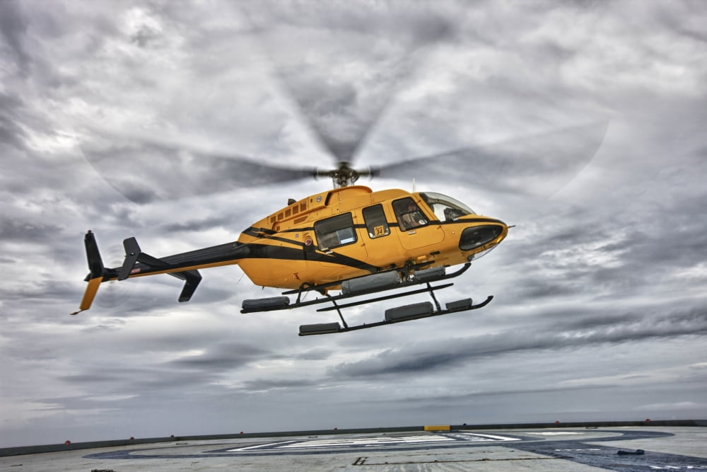 A Bell 407 utility helicopter prepares to land on an oil rig Canvas Art - Terry MooreStocktrek Images (35 x 24)
