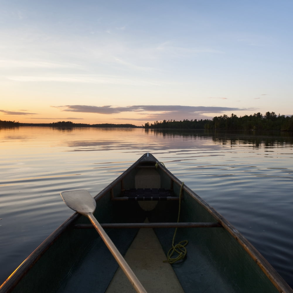 A Boat And Paddle On A Tranquil Lake At Sunset Lake Of The Woods Ontario Canada Canvas Art - Keith Levit Design Pics (24 x 24)