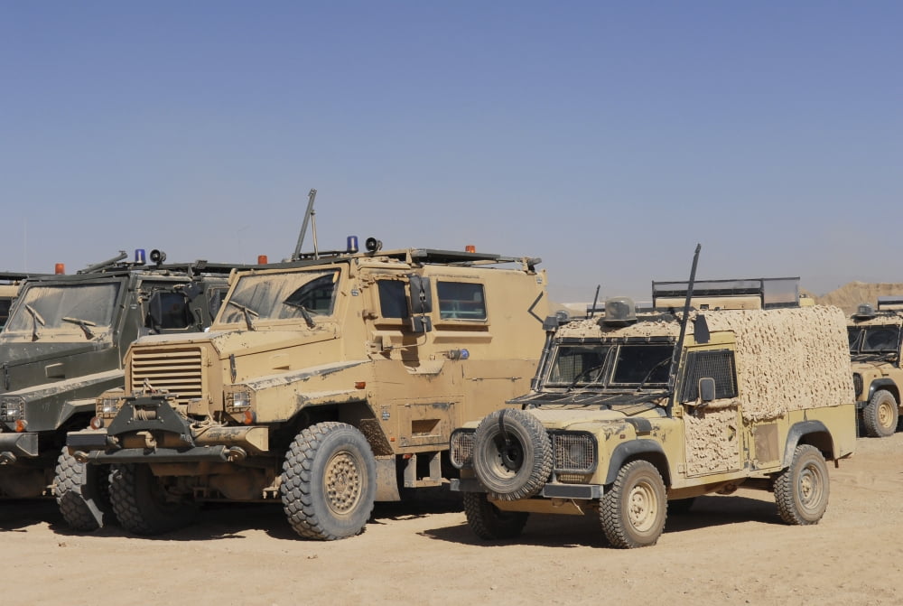 A British Armed Forces Snatch Land Rover parked next to other military vehicles Canvas Art - Andrew ChittockStocktrek Images (35 x 23)
