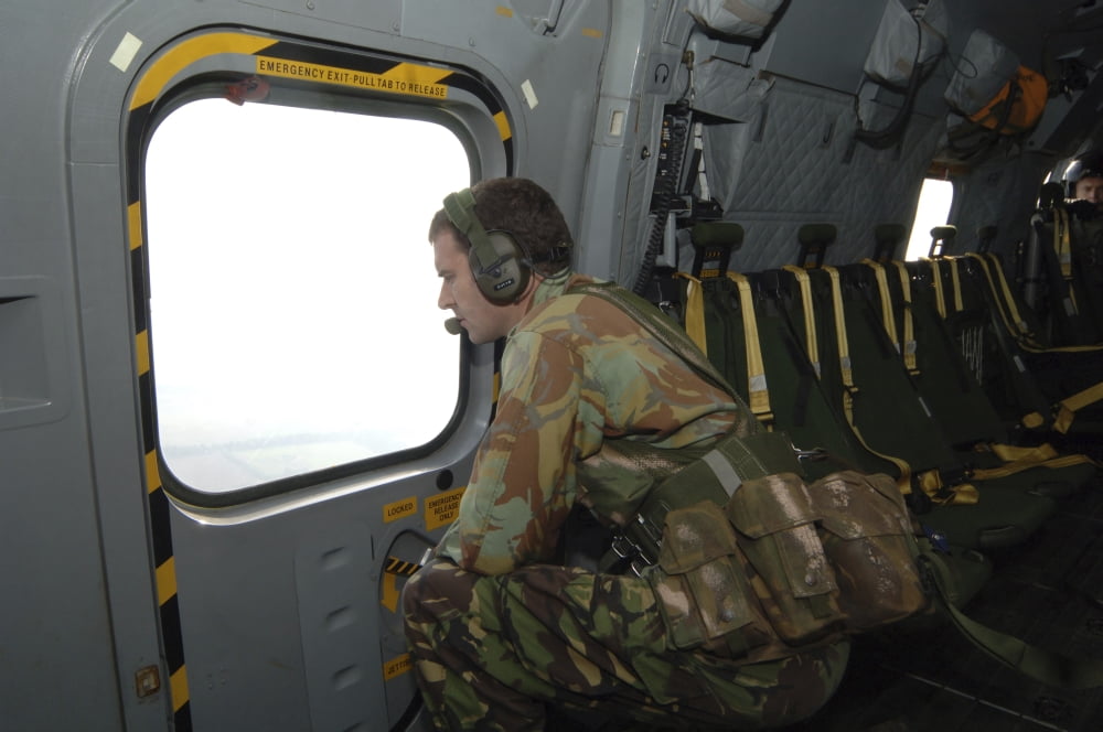 A British Army soldier looks out the window of a RAF Merlin helicopter Canvas Art - Andrew ChittockStocktrek Images (34 x 23)