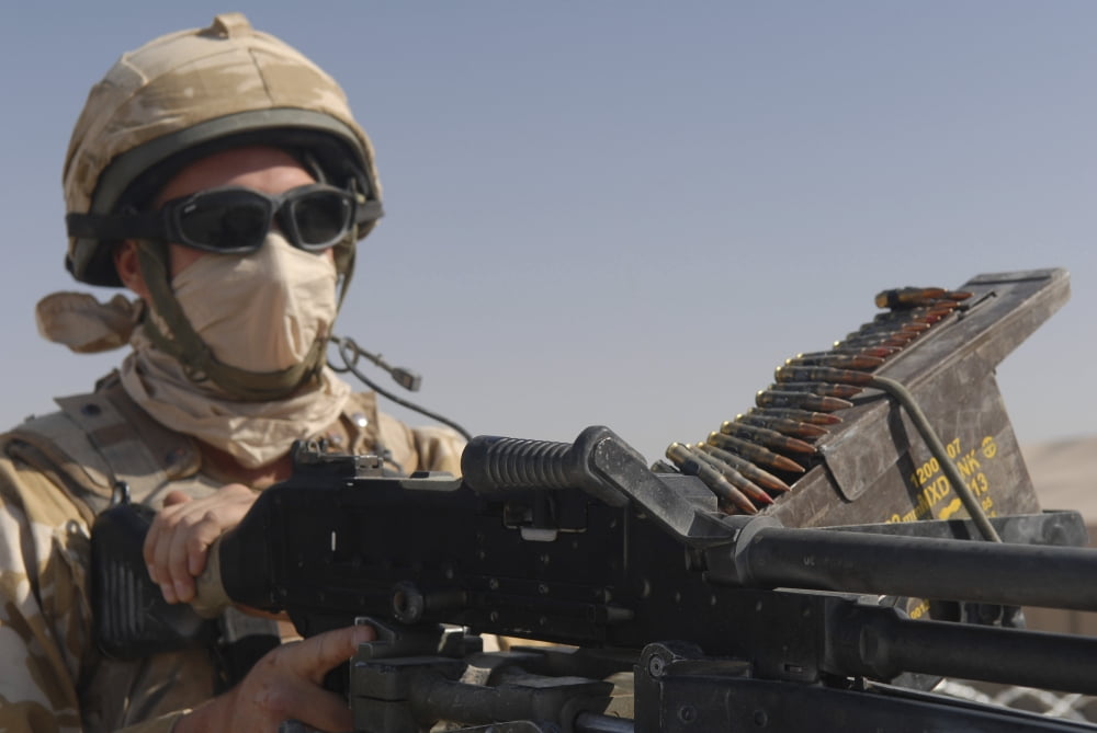 A British Army soldier mans a machine gun mounted on top of a land rover Canvas Art - Andrew ChittockStocktrek Images (34 x 23)