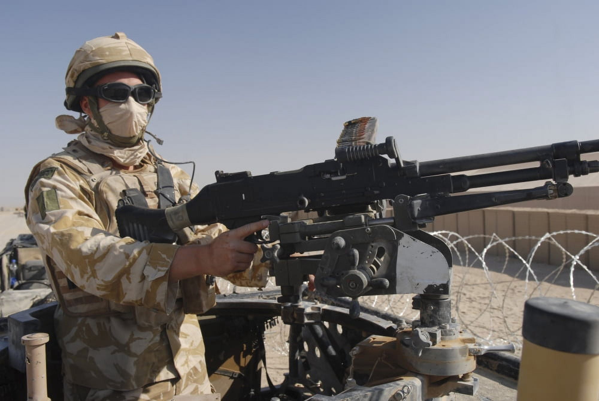 A British Army soldier mans a machine gun mounted on top of a land rover Canvas Art - Andrew ChittockStocktrek Images (34 x 23)
