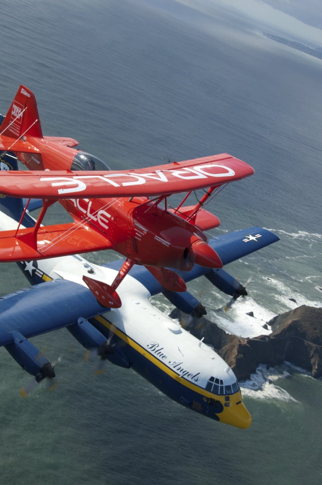 A C-130 Hercules Fat Albert aircraft and biplane fly over San Francisco Bay Canvas Art - Stocktrek Images (23 x 35)