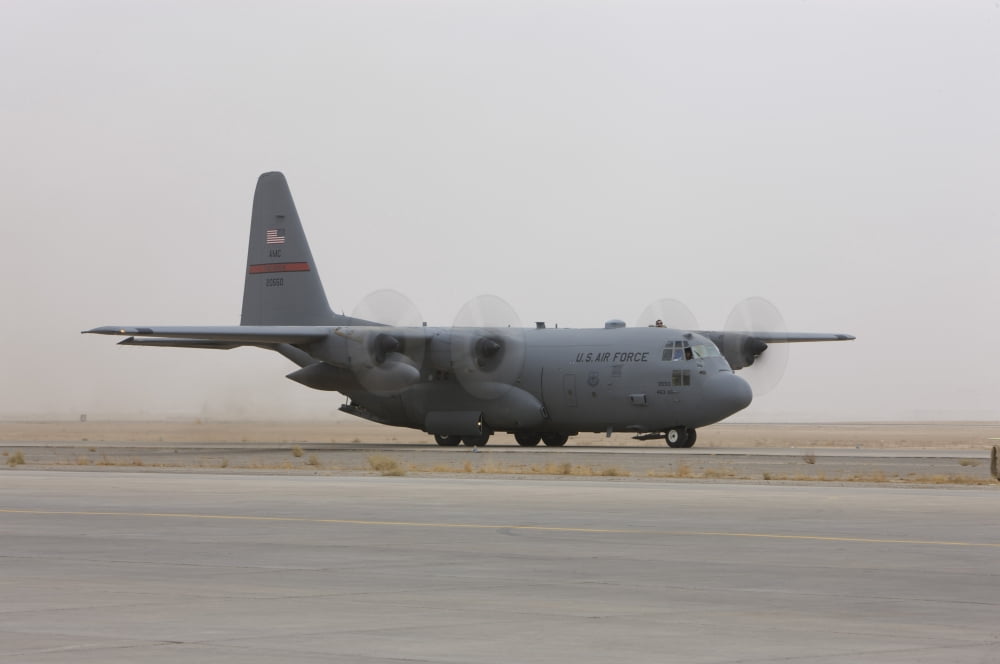 A C-130 Hercules aircraft taxis on the tarmac Canvas Art - Terry MooreStocktrek Images (18 x 12)