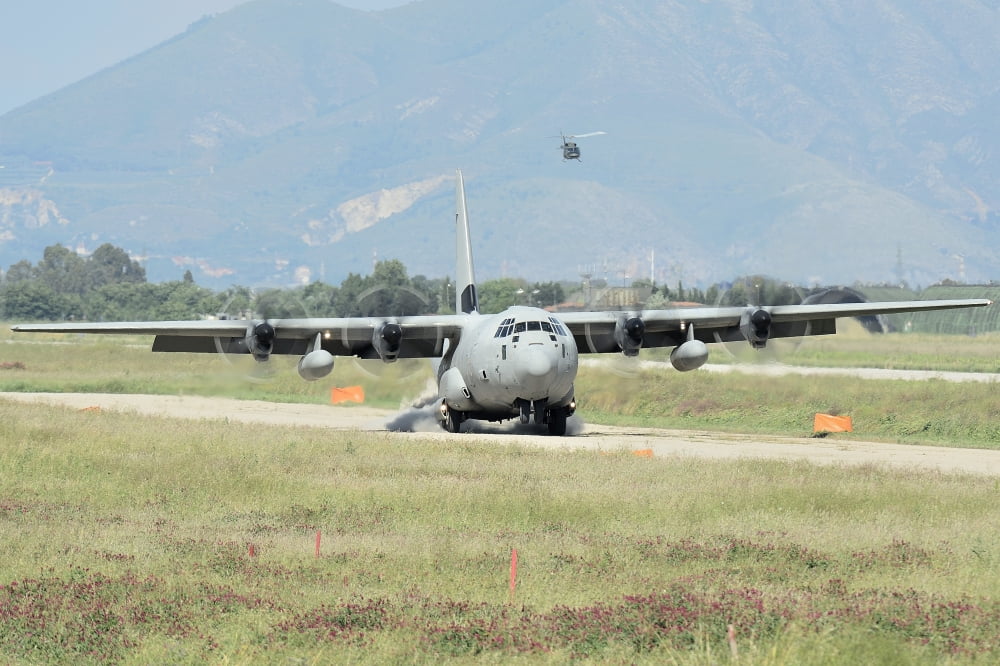 A C-130 Hercules of the Italian Air Force landing on an unpaved landing strip Canvas Art - Remo GuidiStocktrek Images (18 x 12)
