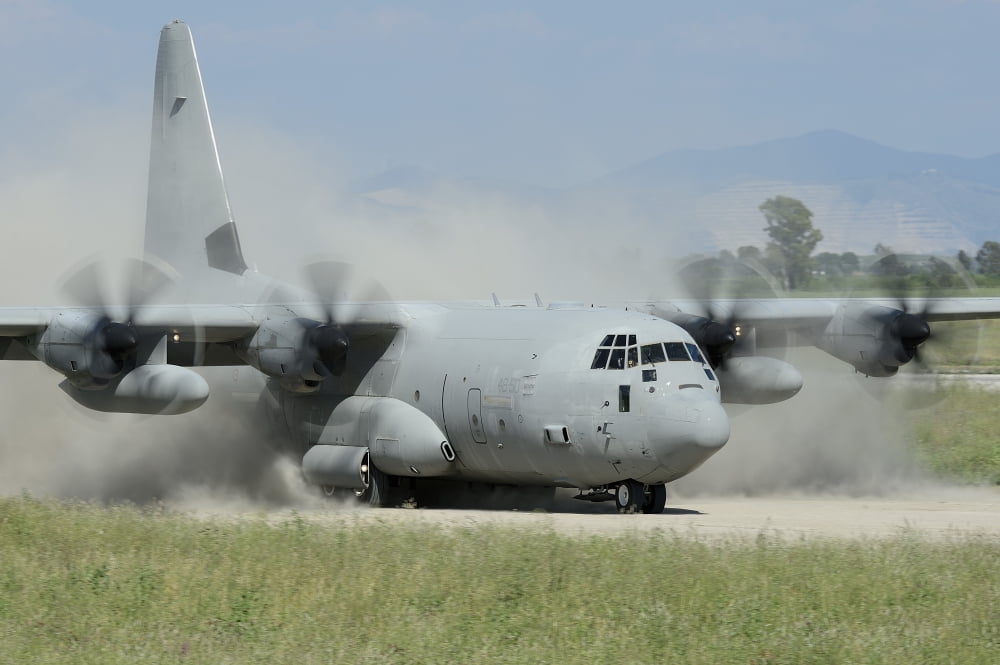 A C-130 Hercules of the Italian Air Force landing on an unpaved landing strip Canvas Art - Remo GuidiStocktrek Images (35 x 23)