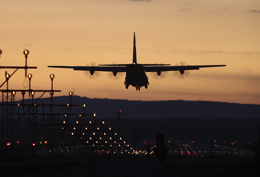 A C-130J Super Hercules landing at Ramstein Air Base Germany at dusk Canvas Art - Timm ZiegenthalerStocktrek Images (18 x 12)