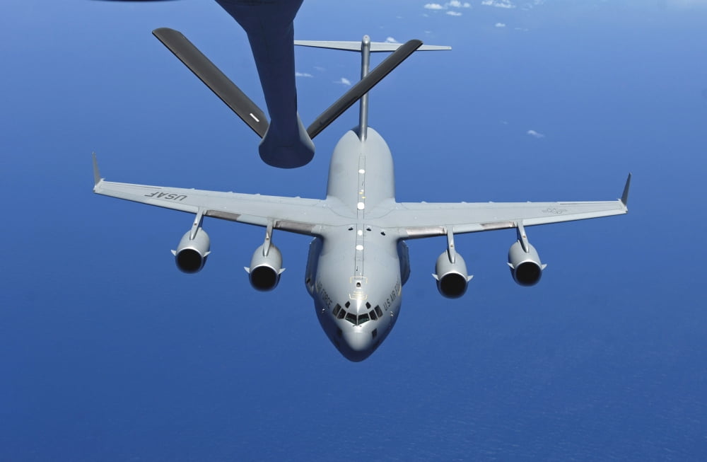 A C-17 Globemaster III approaches the boom of a KC-135 Stratotanker Canvas Art - Stocktrek Images (34 x 23)