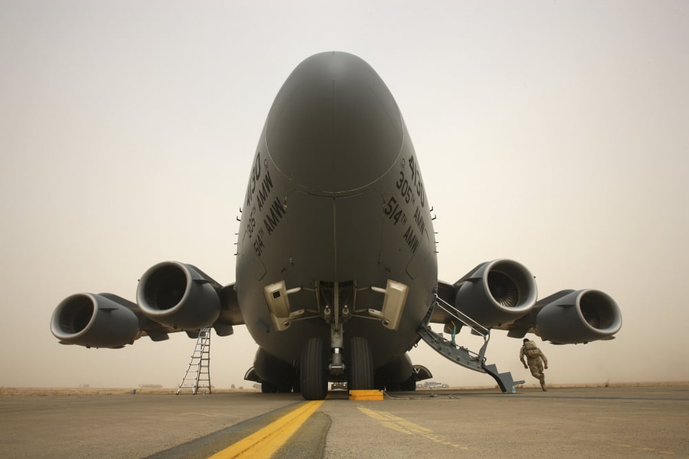 A C-17 Globemaster III sits on the runway at COB Speicher Iraq Canvas Art - Terry MooreStocktrek Images (18 x 12)