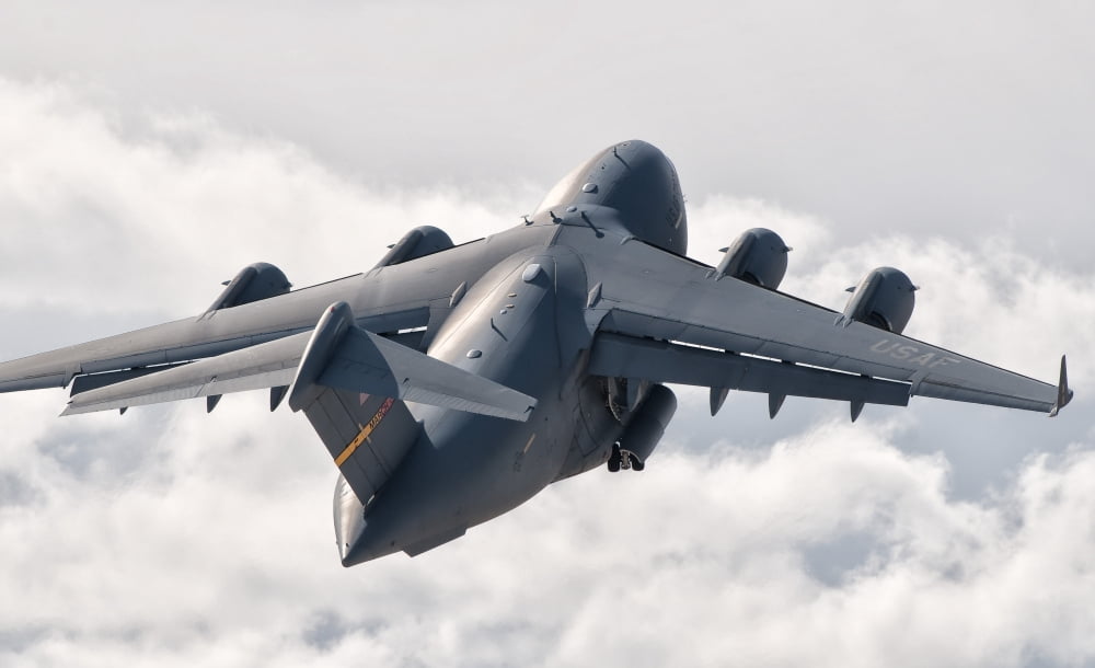 A C-17 Globemaster flying above the clouds over Nellis Air Force Base Nevada Canvas Art - Giovanni CollaStocktrek Images (36 x 22)