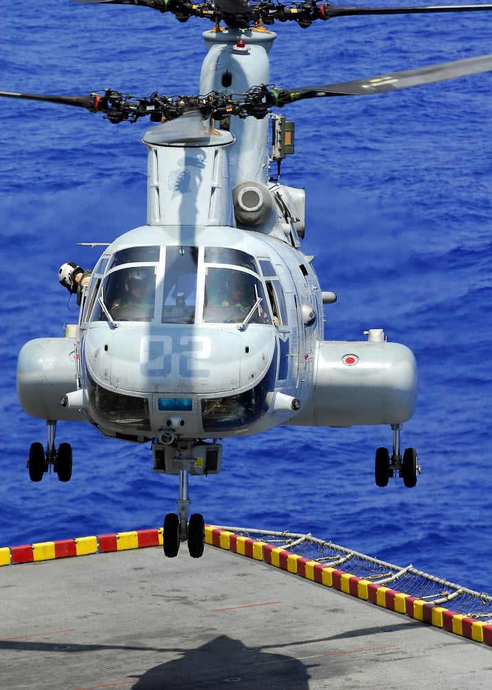A CH-46E Sea Knight helicopter prepares to land on the flight deck of USS Peleliu Canvas Art - Stocktrek Images (24 x 34)