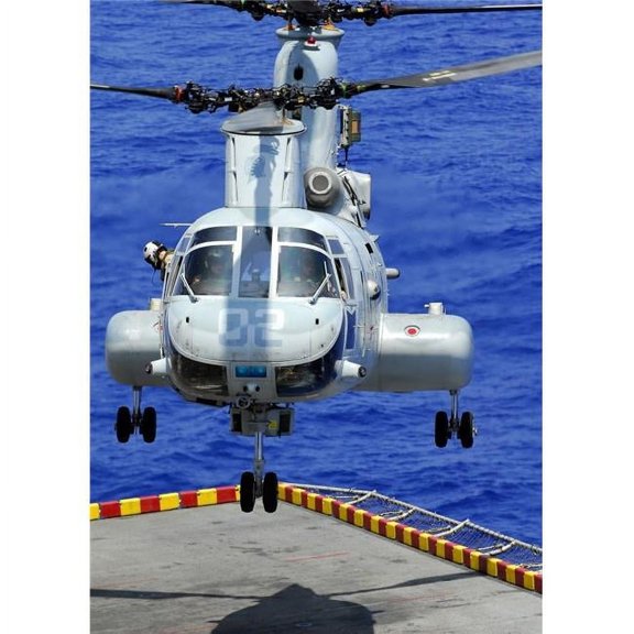 A CH-46E Sea Knight helicopter prepares to land on the flight deck of USS Peleliu Poster Print