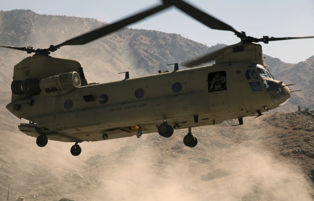 A CH-47 Chinook helicopter kicks up dust as it lands in Afghanistan Canvas Art - Stocktrek Images (35 x 23)