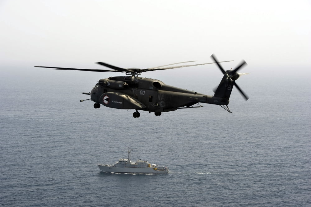 A CH-53 Sea Stallion flies above the mine countermeasures ship USS Ardent Canvas Art - Stocktrek Images (35 x 24)
