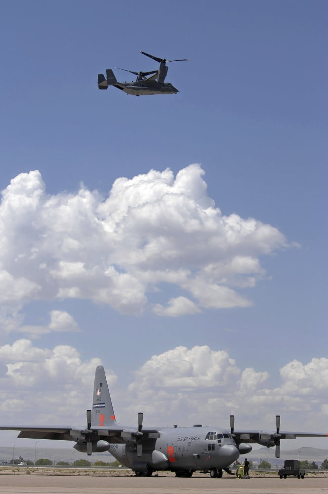 A CV-22 Osprey flies over a C-130 Hercules Canvas Art - Stocktrek Images (23 x 34)