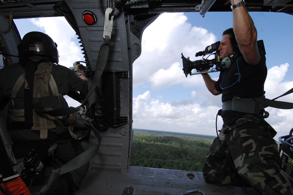 A Cinematographer videotapes a soldier firing the GAU-2 from an HH-60 Pave Hawk Canvas Art - Stocktrek Images (34 x 23)