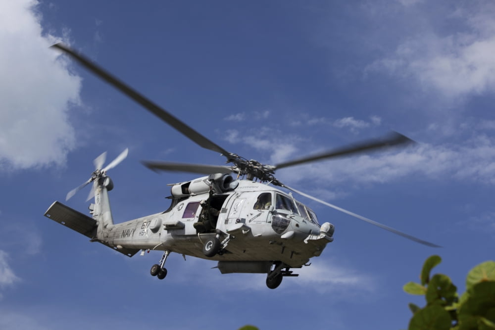 A Crew Chief looks out the side door of a helicopter in flight Canvas Art - Michael WoodStocktrek Images (17 x 12)