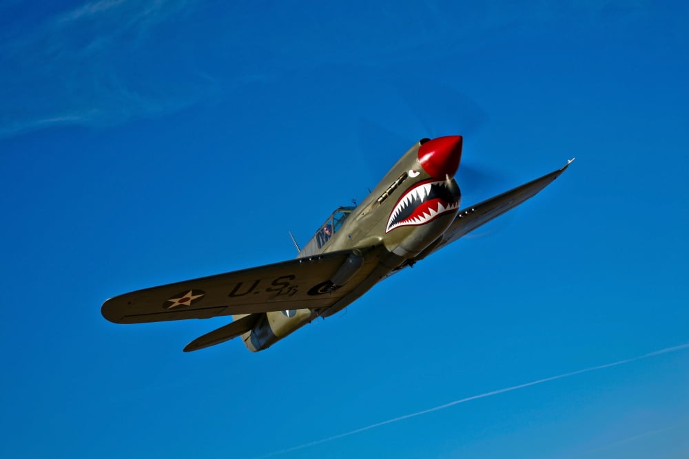 A Curtiss P-40E Warhawk in flight near Chino California Canvas Art - Scott GermainStocktrek Images (18 x 12)