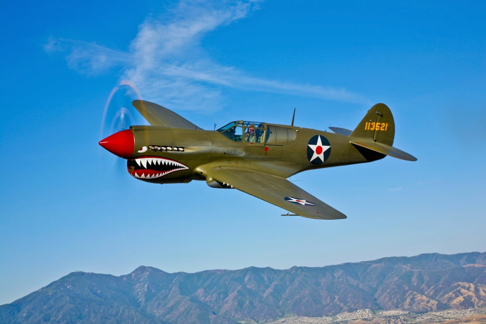 A Curtiss P-40E Warhawk in flight near Chino California Canvas Art - Scott GermainStocktrek Images (35 x 23)