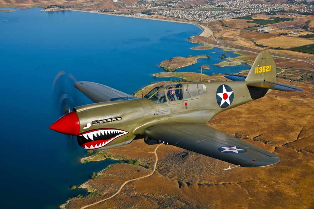 A Curtiss P-40E Warhawk in flight near Chino California Canvas Art - Scott GermainStocktrek Images (35 x 23)