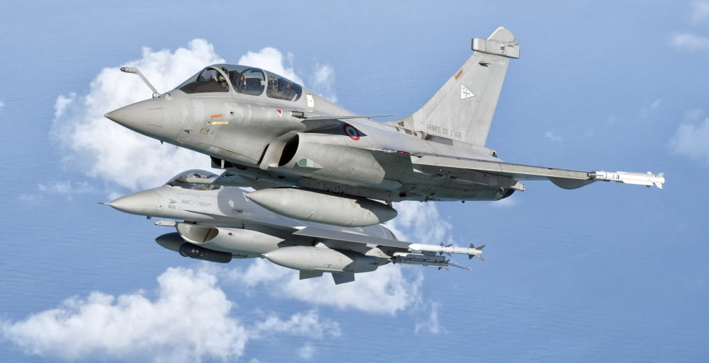 A Dassault Rafale of the French Air Force flys alongside a US Air Force F-16C Fighting Falcon Canvas Art - Giovanni CollaStocktrek Images (20 x 10)