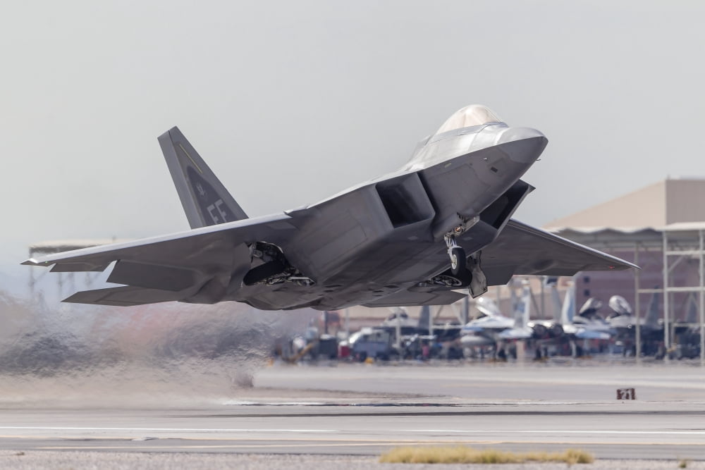 A F-22 Raptor of the US Air Force launches from Nellis Air Force Base Nevada Canvas Art - Rob EdgcumbeStocktrek Images (34 x 23)