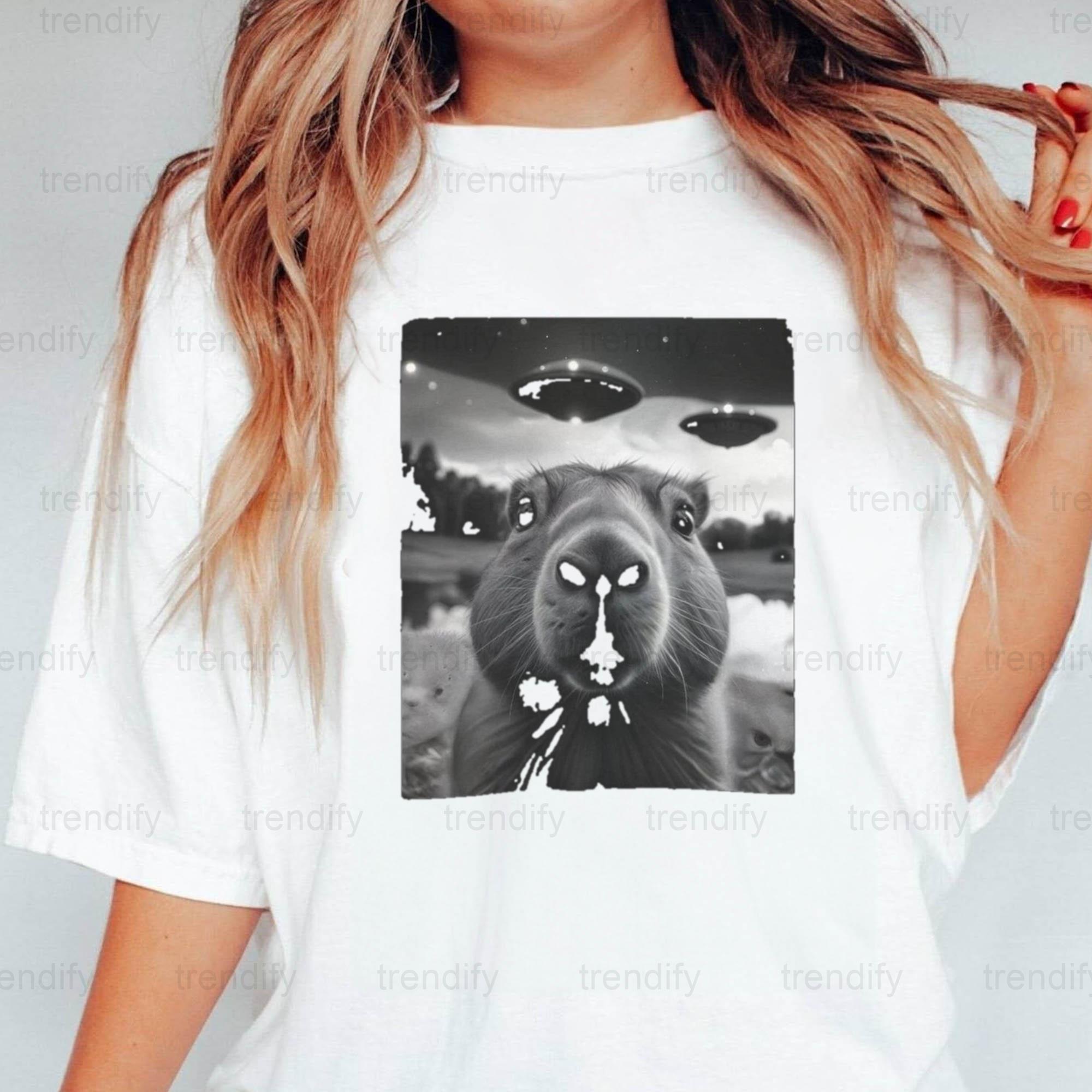 A funny capybara in a flying saucer a cute rodent in space art unisex
