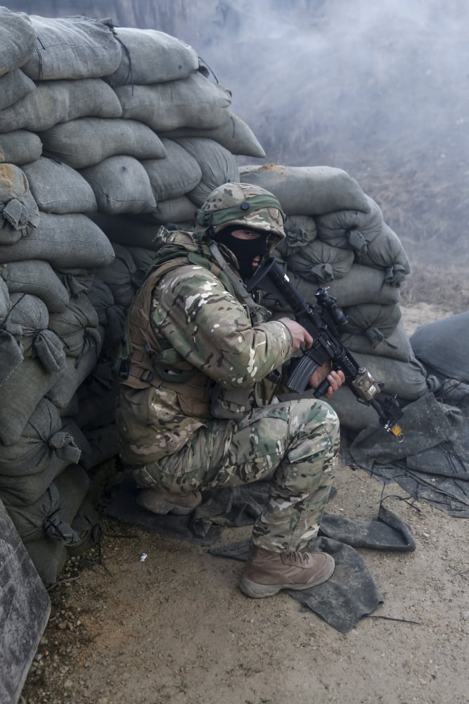 A Georgian soldier takes cover while receiving simulated fire Canvas Art - Stocktrek Images (23 x 34)