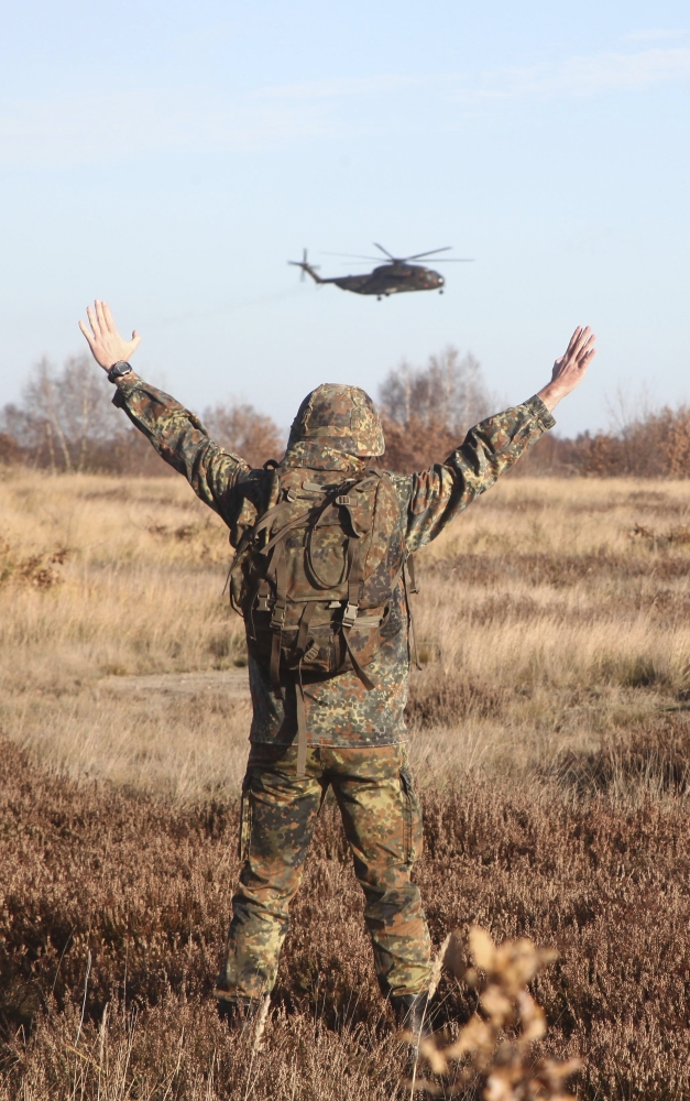 A German Army soldier guides a CH-53GS to the landing zone Canvas Art - Timm ZiegenthalerStocktrek Images (23 x 36)