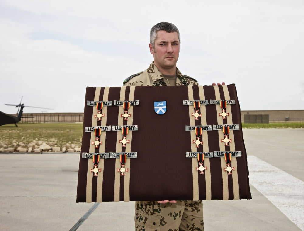 A German soldier holds a display of German Gold Cross medals Canvas Art - Terry MooreStocktrek Images (16 x 13)