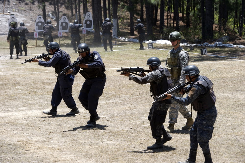 A Green Beret walks with TIGRES trainees during advanced rifle training Canvas Art - Stocktrek Images (34 x 23)