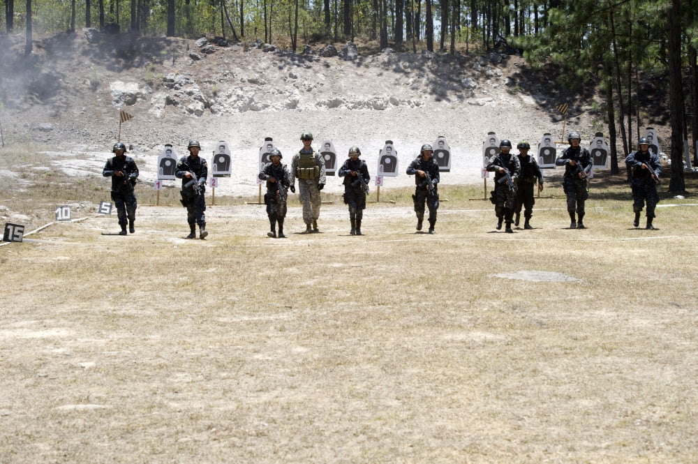 A Green Beret walks with TIGRES trainees during advanced rifle training Canvas Art - Stocktrek Images (34 x 23)