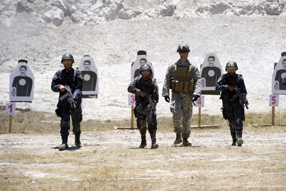 A Green Beret walks with TIGRES trainees during advanced rifle training Canvas Art - Stocktrek Images (34 x 23)