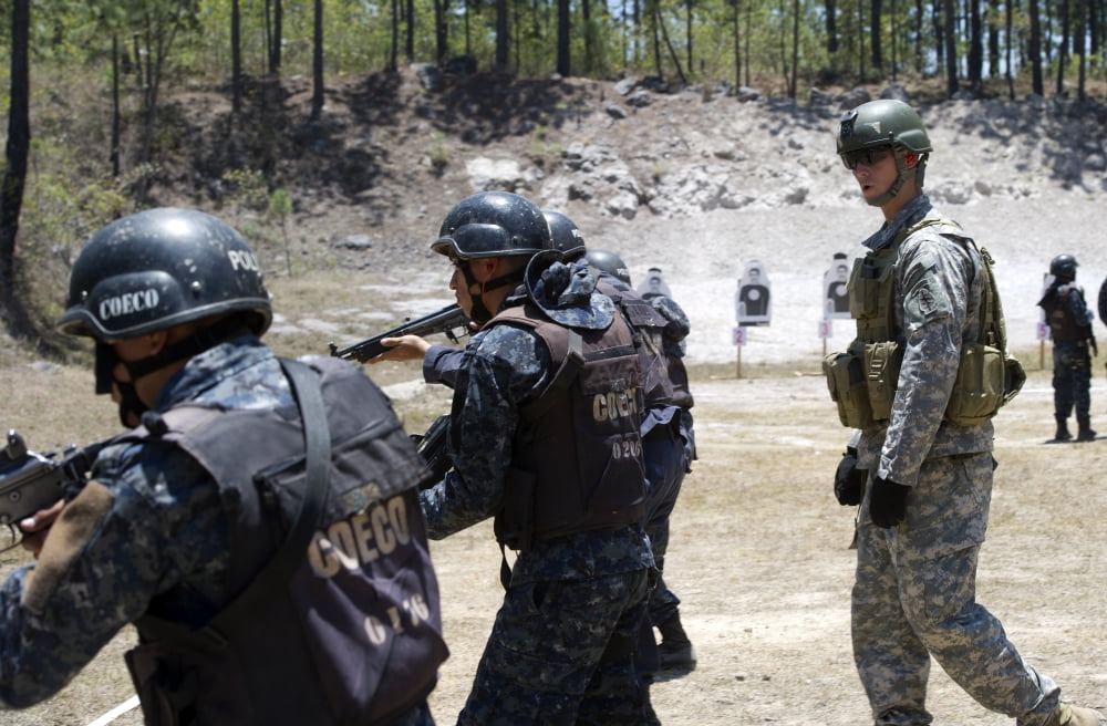 A Green Beret walks with TIGRES trainees during advanced rifle training Canvas Art - Stocktrek Images (34 x 23)