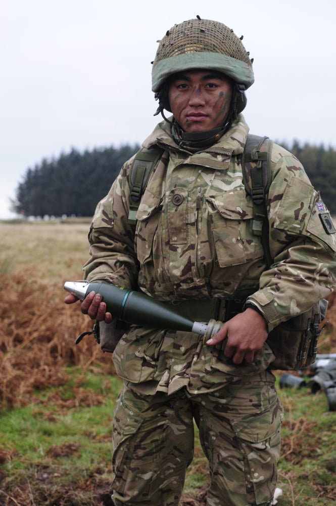 A Gurkha soldier holding a 81mm high-explosive mortar round Canvas Art - Andrew ChittockStocktrek Images (23 x 35)